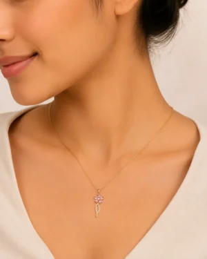 Pink Flora Spark Pendant Necklace featuring a delicate pink crystal flower pendant with gold finish