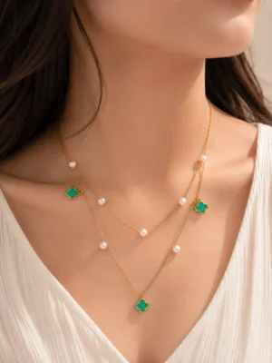 Green Double Layered Pearl Necklace featuring pearl accents and emerald green clover charms on layered gold chains
