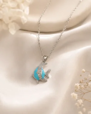 Blue Fish Pendant Necklace featuring a silver fish pendant with a turquoise-blue stone and crystal detailing