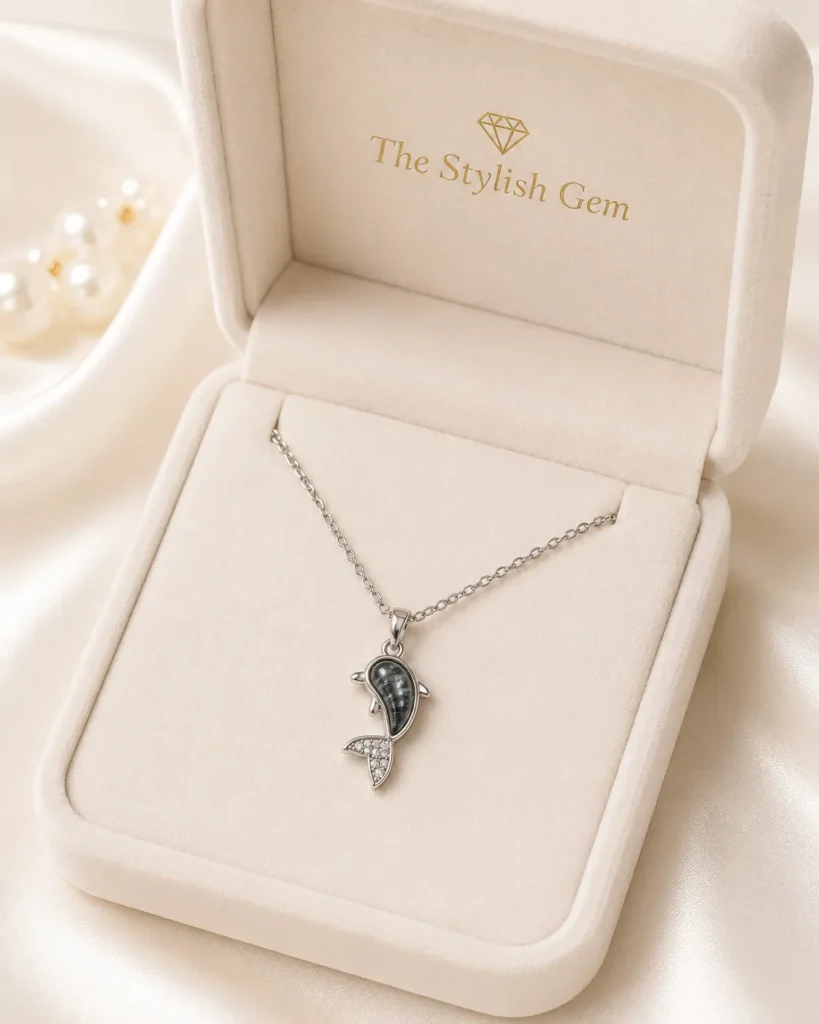 Dolphin Pendant Necklace featuring a silver dolphin pendant with marbled grey stone and crystal detailing
