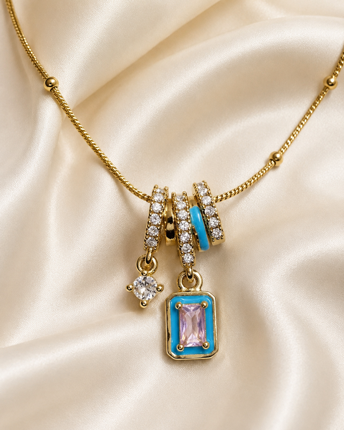 Blue Pink Crystal Charm Pendant Necklace Blue Pink Crystal Charm Pendant Necklace featuring blush pink crystal, turquoise enamel accents, and sparkling white crystal charms
