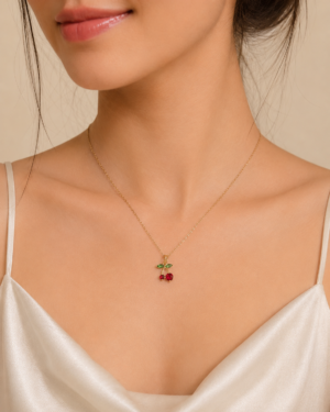Cherry Blossom Pendant Necklace featuring glossy red cherries and sparkling green crystal leaves in a premium gold finish