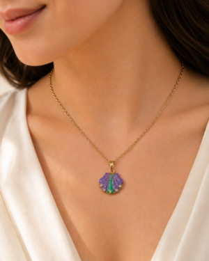 Purple Tide Necklace featuring a purple and emerald shell pendant with sparkling crystal accents in a gold finish