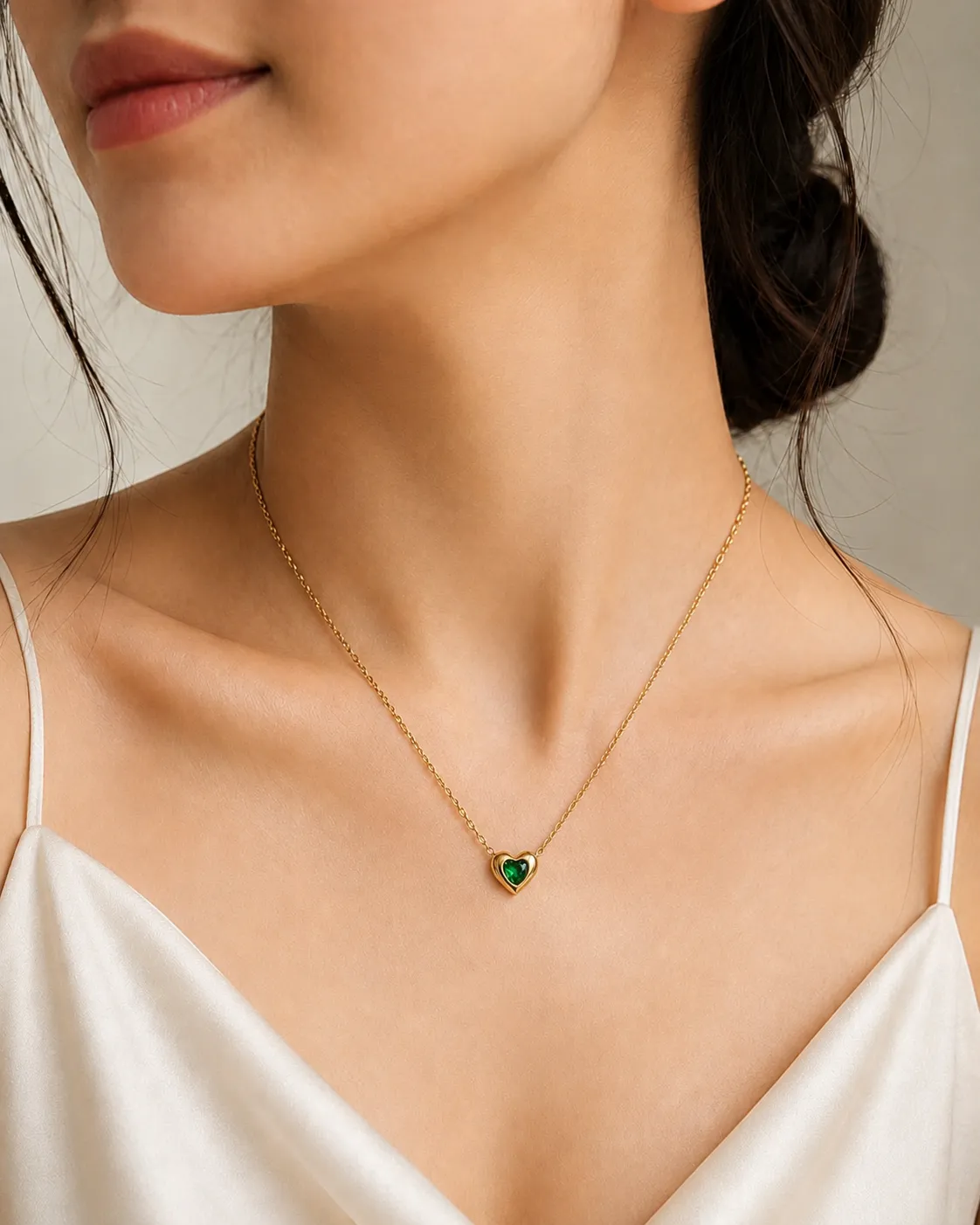 Green Heart Pendant Necklace Green Heart Pendant Necklace featuring an emerald-green heart crystal set in a premium gold heart frame