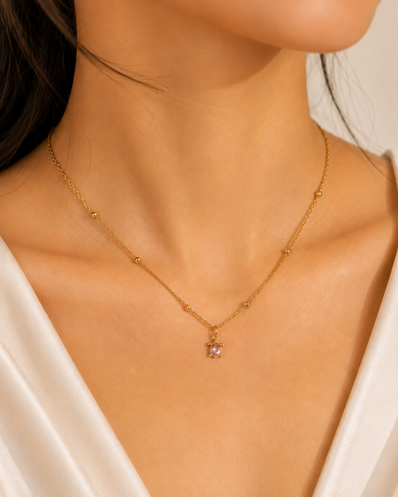Blush Turtle Pendant Necklace featuring a sparkling pink crystal set in a premium gold turtle pendant