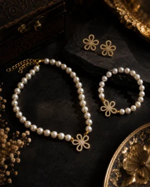 Flora Pearl Jewellery Set featuring pearl necklace, pearl bracelet, and crystal floral earrings in gold finish