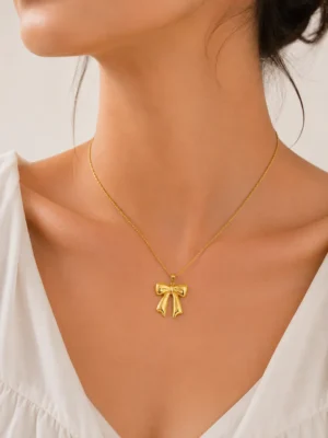 Golden bow pendant necklace close-up